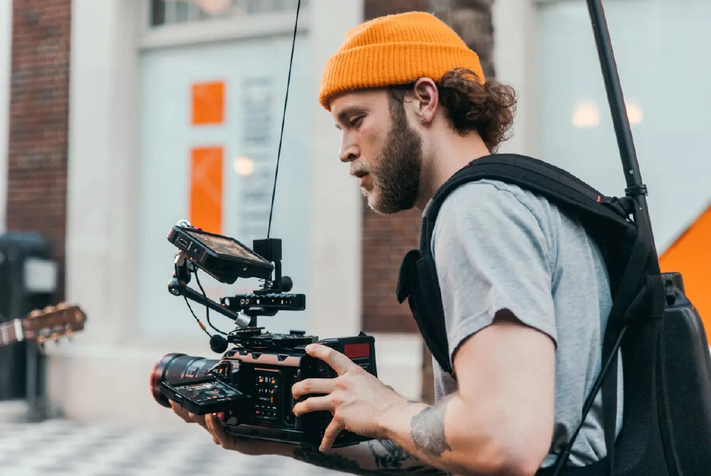 a person with yellow cap with camera